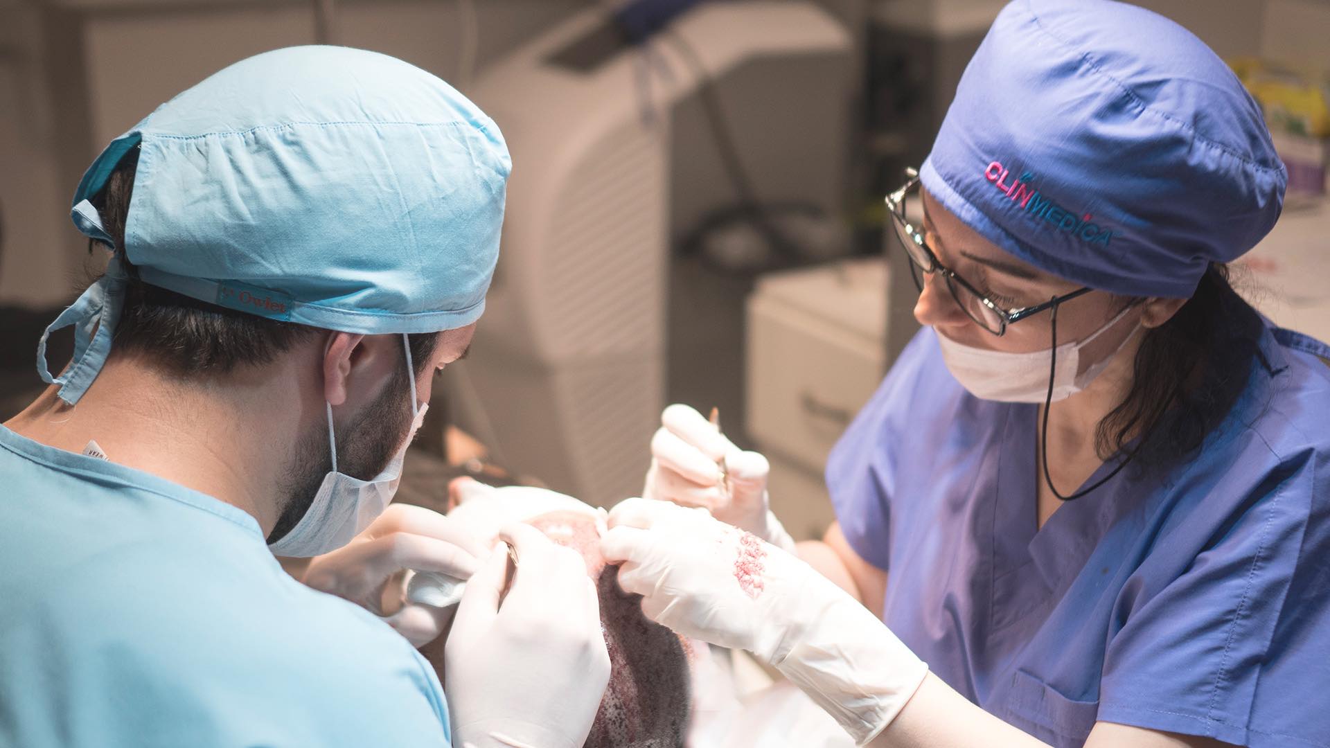 a group of people wearing scrubs and surgical caps