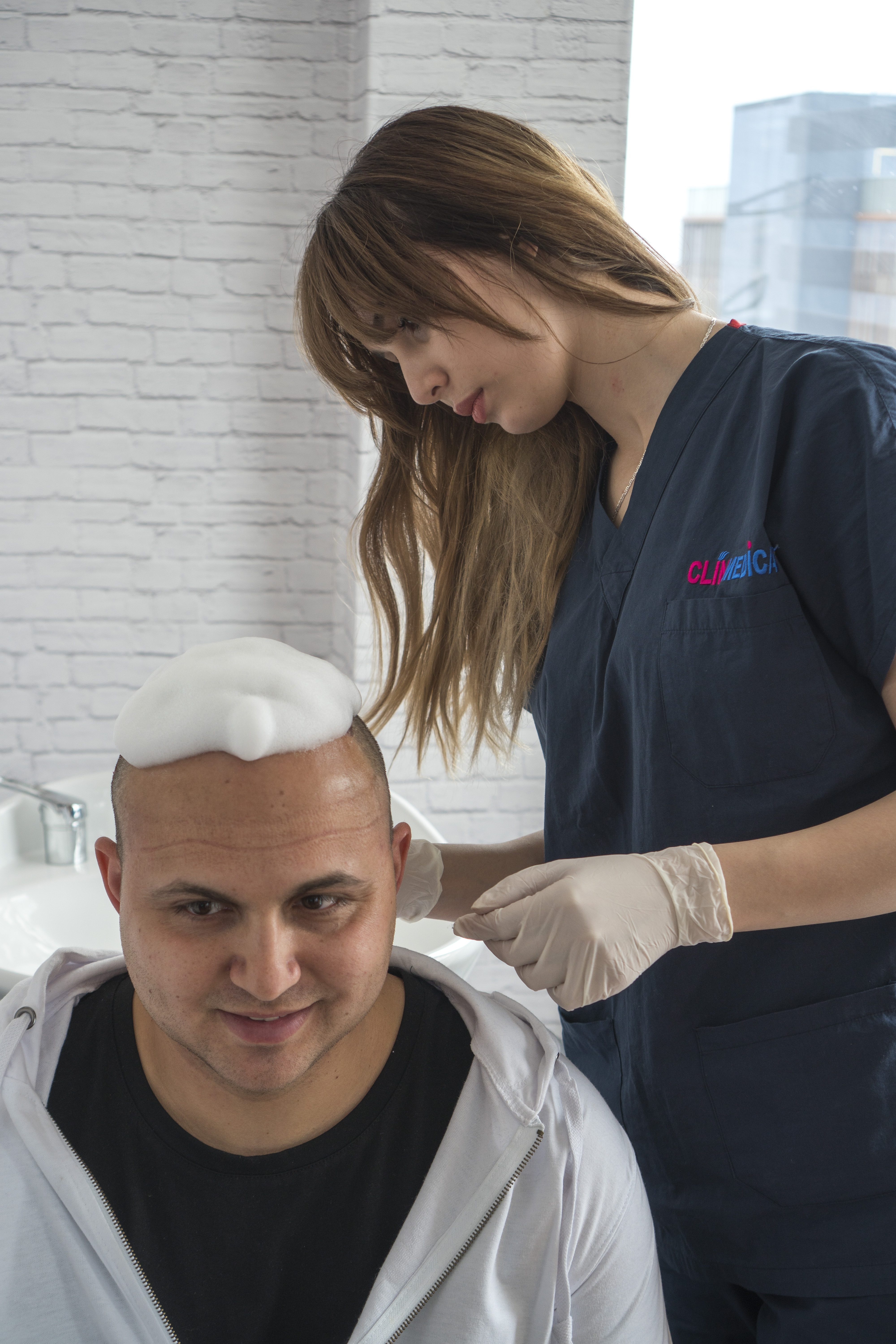 a woman washing a man's head
